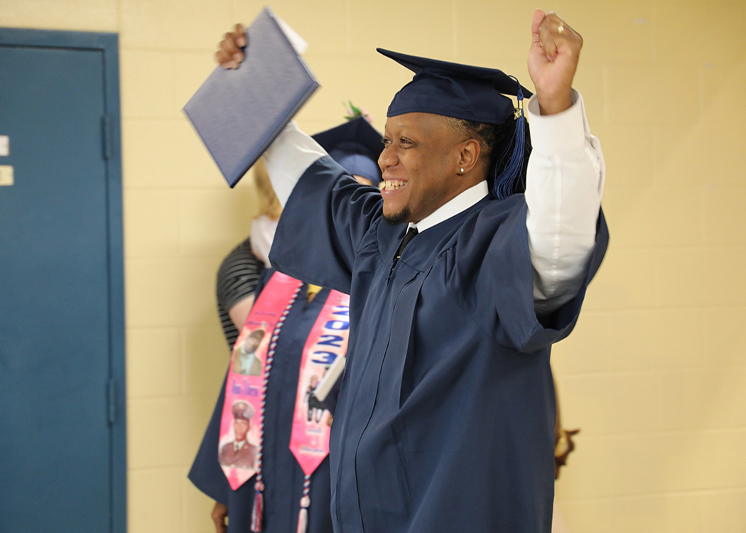 Graduate smiling from Commencement 2024