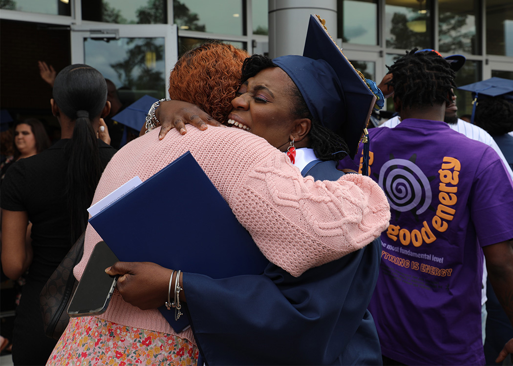 Graduate smiling from Commencement 2024