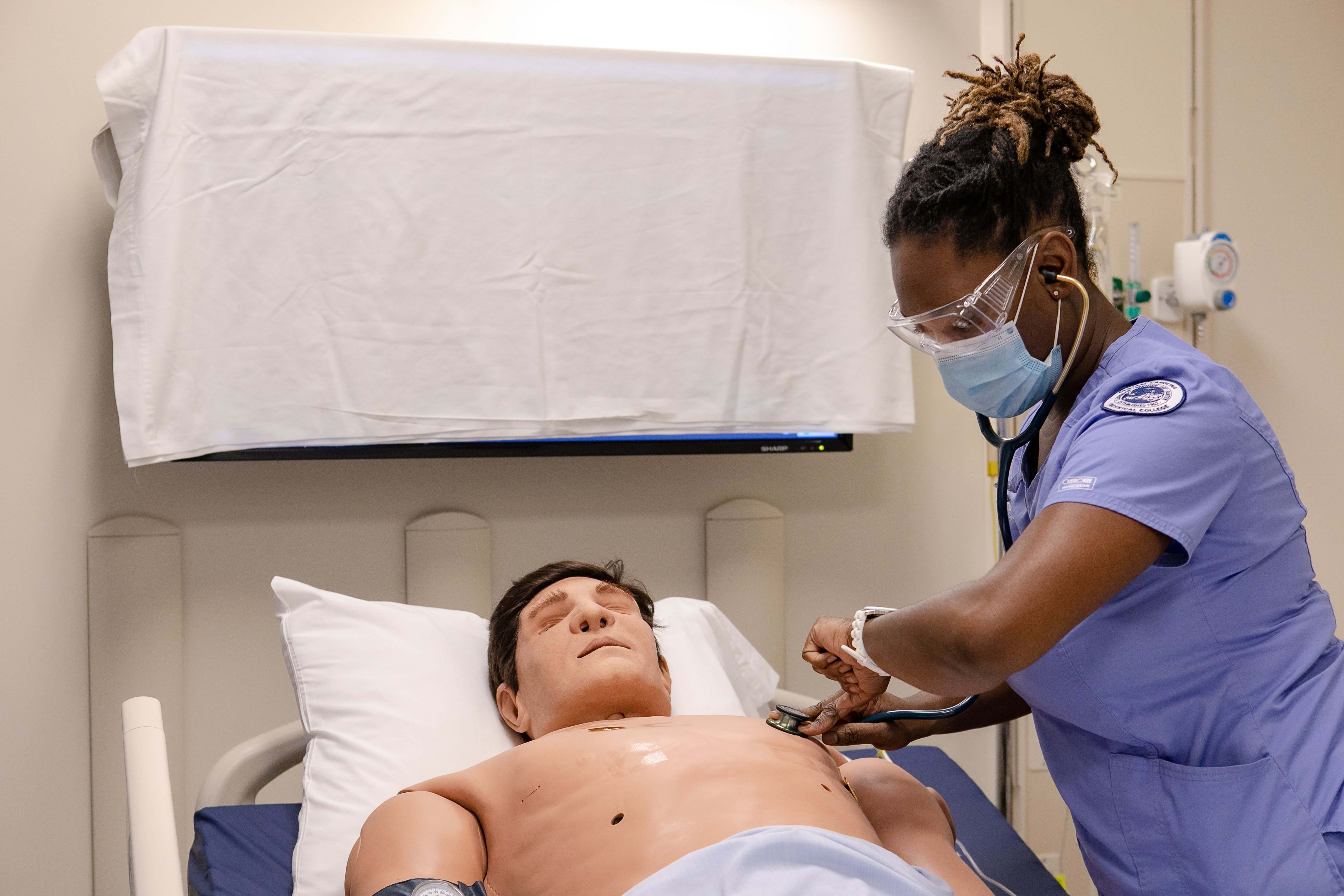 CNA student practicing skills on mankin