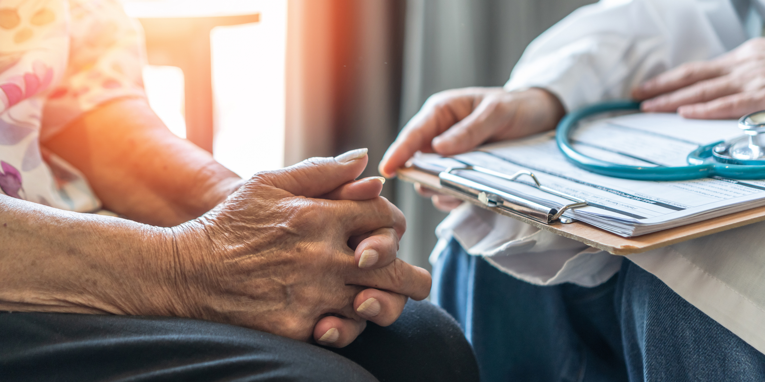 Geriatric doctor (geriatrician) consulting and diagnostic examining elderly senior adult patient (older person) on ageing and mental health care in medical clinic office or hospital examination room